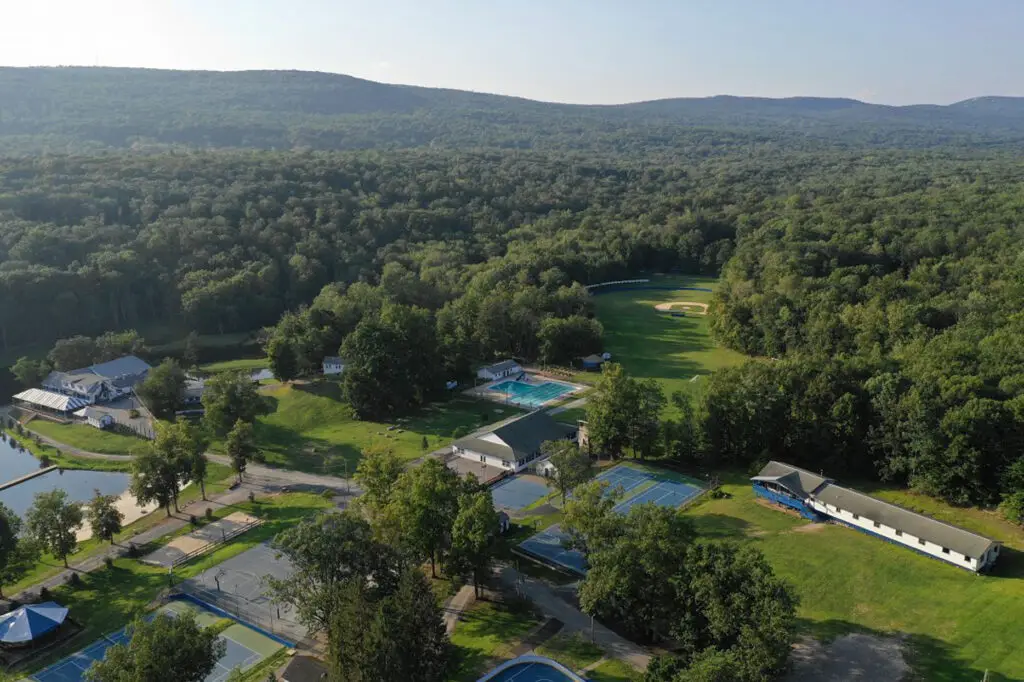 Aerial view of Camp Echo, Bloomingburg, New York, with its private lake and wooded acres