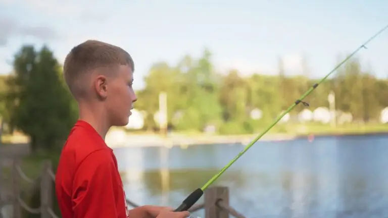 Young camper fishing from the dock at Camp Echo