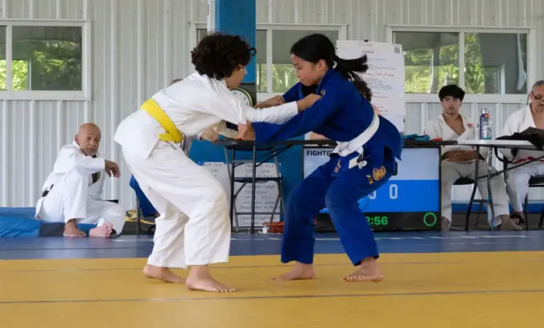 Two young judoka gripping up during the Shiai at International Judo Camp
